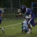 Pioneer senior running back Marquise Thomas bobbles the ball during a run to score a touchdown in the game against Skyline on Friday. Daniel Brenner I AnnArbor.com